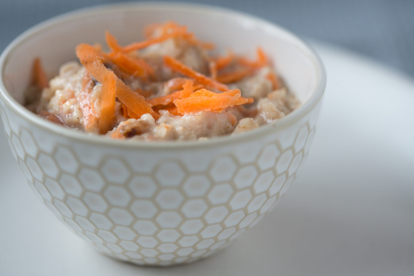 a small bowl of porridge with carrot on top