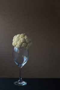 Head of cauliflower on an empty wine glass